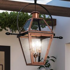 An UQL1374 Rustic Outdoor Pendant, 30''H x 28''W, Rustic Copper Finish from the Paris collection by Urban Ambiance, featuring copper and brass fixtures, hanging elegantly over a patio. Front Porch Chandelier Outdoor, Copper Light Fixture, Antique Lanterns, Copper Lantern, Colonial Design, Cabin Lighting, Gas Lanterns, Bronze Lighting, Lantern Design