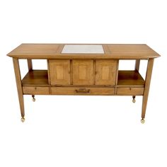 a wooden table with two drawers on one side and a glass top on the other