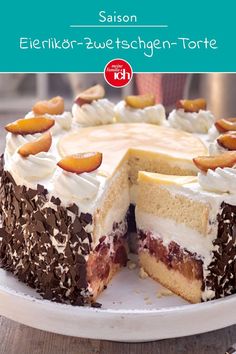 a cake with white frosting and fruit on top