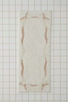 a white towel on top of a tiled floor