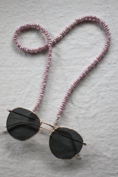 Lilac has been *such* a trendy colour this year and this set of glasses chains is the perfect lilac shade with a pearly finish! We love the unique shape of these beads too!  24" long  Sunglasses chains are back and trendier than ever before! All of our sunglasses/glasses chain are made using vintage beads from reclaimed necklaces! We love that we are able to rework them into something modern and fun! They're like jewellery for your glasses! These sunglasses chains are built to last using strong Trendy Adjustable Glasses Chains For Party, Trendy Lavender Jewelry For Party, Trendy Pearl Glasses Chain As Gift, Trendy Handmade Glasses Chains For Party, Elegant Summer Glass Necklaces, Elegant Summer Party Glasses Chains, Handmade Glasses Chains For Summer Party, Handmade Summer Party Glasses Chains, Elegant Beaded Glasses Chains For Festivals