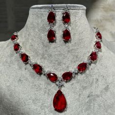 Handmade Style: Necklace and Earrings Set Material: Platinum Plated, Lab Simulated Ruby and White Sapphire Stones Imported Size: Earrings measure 1.60 inches long. Please Note: This necklace and earrings are sold as a set. Item Number: 7074R Red Diamond Jewelry, Ruby Necklace Aesthetic, Red Prom Necklace, Red Diamond Jewelry Set, Jewelry Ruby, Ruby Jewelry Set, Red Jewel Necklace, Ruby Set, Ruby Stone Necklace