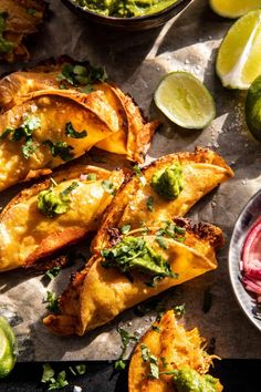 some food is laying out on a table with limes and other foods around it