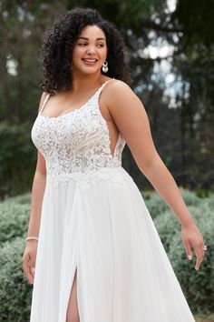 a woman in a white dress posing for the camera