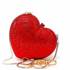 Red Heart Novelty Purse Clutch is a beautiful mini clutch covered in radiating ruby red crystals. This stunning piece is complete with gold color hardware and removable gold snap hook chain. Wear it in hand, on shoulder or as crossbody. It is the perfect statement clutch for a glamorous ensemble. Beautiful and functional, this clutch can hold securely your keys, cards, and other small essentials. Details: Measurement: 5in length x 4in high x 1.5in width Color: Red crystals Lining: golden vegan l Hand On Shoulder, Nye 2023, Silver Clutch Purse, Heart Clutch, Novelty Purses, Statement Clutch, Formal Evening Wear, Silver Clutch, Small Clutch