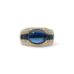 Our Estate Blue Sapphire Cabochon Ring with Baguette Side Stones exudes elegance and sophistication. At its centerpiece is a blue sapphire cabochon, a gemstone cut into a smooth, rounded shape, artfully showcasing the natural beauty and depth of the sapphire's color. Available in 18K Yellow Gold Available in a size 6.75 Ring can be resized between sizes 6-7.5 for an additional fee. Please contact our Team at info@stephaniegottlieb.com for more information. Sapphire weight = 6.16 carats Diamond weight = 1.5 carats Diamond quality = G/H color, VS1 clarity Origin = Italy Estimated from the 1990s Vintage and Antique jewelry should be handled and worn with extra care. This item is FINAL SALE Sapphire Cabochon Ring, Baguette Side Stones, Sapphire Cabochon, Sapphire Color, Diamond Cocktail Rings, Cabochon Ring, Band Bracelet, Diamond Shop, Bracelet Collection