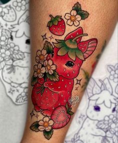 a tattoo design with strawberries and flowers on the leg, which is very cute