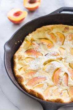 a pie in a pan with peaches on the side