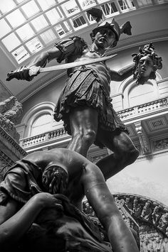 black and white photograph of a statue in the middle of a building