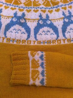 a yellow sweater with blue and white designs on it