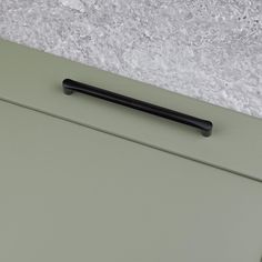 a black handle on the side of a green cabinet