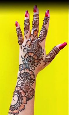 a woman's hand with henna tattoos on it