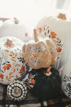 several painted pumpkins sitting on top of a table