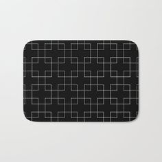 a black and white geometric pattern bath mat