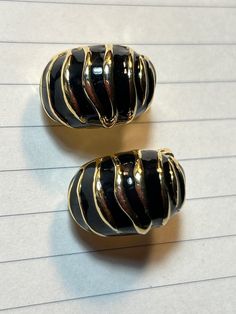 Vintage Clip on earrings in black and gold.  Conch Shell shape Heavy clip on is in good shape Vintage Black Enamel Clip-on Earrings, Vintage Black Metal Clip-on Earrings, Vintage Black Clip-on Earrings, Black Metal Clip-on Earrings, Vintage Clip On Earrings, Gold Clips, Conch Shell, Vintage Clip, Art Accessories