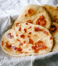 two pita breads sitting on top of a white napkin