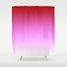 a red and pink shower curtain hanging on a white wall