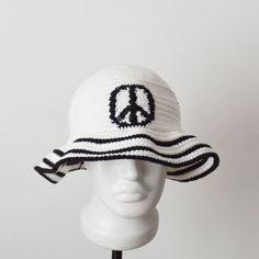 a white and black hat with peace on it