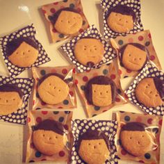 some cookies that have been decorated to look like people with faces on them and polka dots