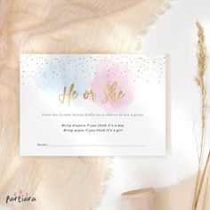 a white card with gold foil lettering on it next to some pink and blue flowers