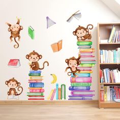 there is a wall decal with monkeys on it and books in the room next to it