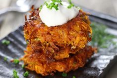 a close up of a plate of food with broccoli and sour cream on top