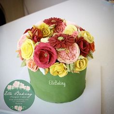 a cake decorated with flowers on top of a white table and a sticker that says edible baking