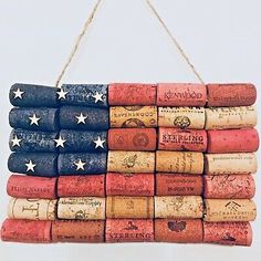 an american flag made out of wine corks hanging from a rope on a wall