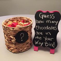 there is a basket with chocolates in it next to a sign that says guess how many chocolates are in the your way bin