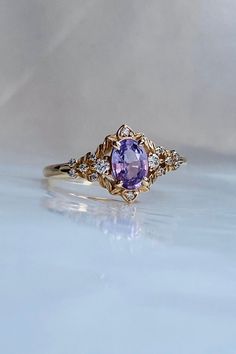 a ring with an amethorate and diamonds on it