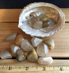 some rocks and a ruler on a wooden table