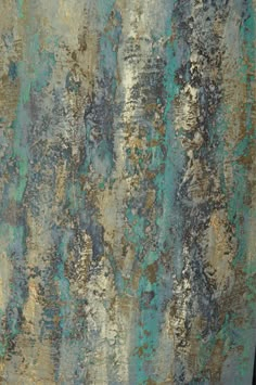 an old rusty metal surface with blue and gold paint