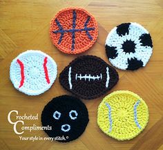 four crocheted sports balls on a wooden table