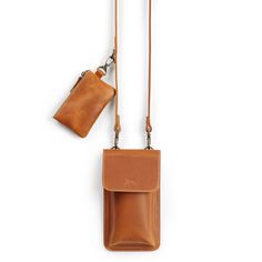 Explore the   Ruby Leather Crossbody Phone Bag with Mini Pouch   — an elegantly designed accessory tailored for everyday convenience. This set features a streamlined phone bag coupled with a matching mini pouch, each crafted from premium leather for durability and a sophisticated appearance. The versatile design includes an adjustable strap with a D-ring for customization and practicality. Perfectly sized to accommodate an iPhone 15 Pro Max or similarly sized phones, this bag ensures all your es Brown Bag With Hidden Phone Sleeve For On-the-go, Classic Phone Bag With Removable Pouch For Everyday, Brown Bags With Hidden Phone Sleeve For On-the-go, Classic Pouch For Mobile Phone Everyday Use, Classic Everyday Mobile Phone Pouch, Classic Mobile Phone Pouch For Everyday Use, Classic Everyday Phone Bag With Cell Phone Pocket, Classic Everyday Phone Bag With Removable Pouch, Brown Phone Bag With Removable Pouch For Everyday