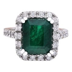 Presenting our exquisite 14K Solid White Gold Diamond Ring adorned with a captivating 5.82 Carat Natural Emerald centerpiece. Meticulously crafted with precision and elegance, this ring epitomizes sophistication and luxury. The stunning emerald weighs 5.02 Carats, measuring 11.00x9.00 mm, showcasing its vibrant green hues and natural beauty. Complementing the emerald are sparkling diamonds totaling 0.80 Carats, with F-G color and VS2-SI1 clarity, adding brilliance and elegance to the piece. With Green Platinum Rings With Pave Setting, Green Platinum Ring With Pavé Setting, Luxury Emerald Cut Gemstone Halo Ring, Emerald Cut Gemstones With Halo Setting, White Gold Gemstone With Emerald Brilliant Cut, Formal Emerald Gemstones With Halo Setting, Luxury Emerald Cut Emerald Ring With Halo Design, Luxury Emerald Rings With Halo Design, Luxury Emerald-cut Emerald Ring With Halo Design