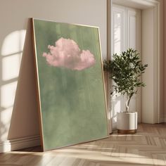 there is a painting on the floor with a pink cloud in the sky above it