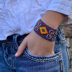 Handmade Purple Beaded Bracelet, Handwoven, Loom, Casual Wristband Jewelry 1.25 x 7.5 Inch Sparkly seed beads where used to create this beautiful beaded bracelet. *Casual Wear Beaded Bracelet *Native American Inspired Design *The bracelet can be secured at one of three lengths with a beaded button. *Handmade in Guatemala Casual Handwoven Beaded Bracelets As Gift, Beaded Brown Friendship Bracelets As Gift, Brown Beaded Friendship Bracelets As Gift, Hippie Style Woven Beaded Bracelets For Gift, Handmade Bohemian Rectangular Friendship Bracelets, Casual Beaded Wristband For Festivals, Handmade Adjustable Orange Cuff Bracelet, Handmade Round Beads Cuff Bracelet For Festival, Friendship Bracelets With Handwoven Round Beads