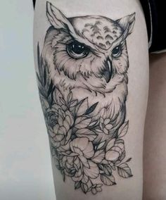 an owl and flowers tattoo on the thigh