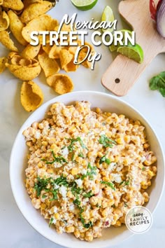 mexican street corn dip in a white bowl with tortilla chips on the side