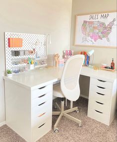 a white desk and chair in a room with a map on the wall behind it