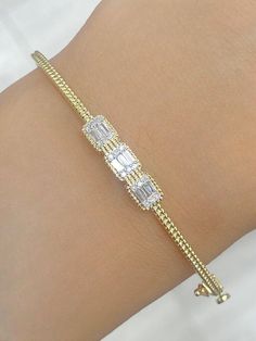 100% Genuine Natural 0.25 CTW Diamond / Baguette Bangle Bracelet in 14 KT    ITEM CONDITION : BRAND NEW . DIAMOND CARAT : 0.25 CTW DIAMOND CUT : ROUND BRILLIANT CUT. DIAMOND COLOR : G-H DIAMOND CLARITY : SI DIAMOND SYMMETRY : EXCELLENT DIAMOND SETTING : PRONG SETTING ITEM NO : 87771 GOLD CARAT : 14 KT  SUGGESTED RETAIL VALUE : $2025.00 Match it with an equally beautiful Chain, Charm & Earring – Available in our Store! ALL ITEMS ARE BRAND NEW! Our Diamonds are 100% Natural and are neither Treated Diamond Bangle Bracelet, Diamond Bracelet Design, Diamond Baguette, Diamond Bangles Bracelet, Bracelet Design, Diamond Settings, Fine Jewelry Bracelets, Diamond Bangle, Diamond Carat