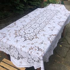 a white table cloth on a wooden bench