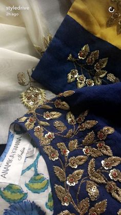 several different colored fabrics with gold and blue designs