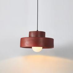 a brown light hanging from a ceiling fixture