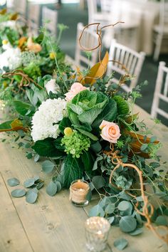 a table with flowers and candles on it