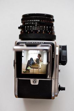 an old fashioned camera with a man on it's screen