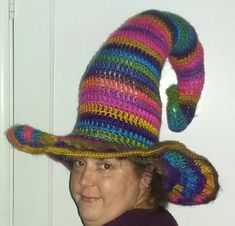 a woman wearing a multicolored knitted hat with an odd shaped brim