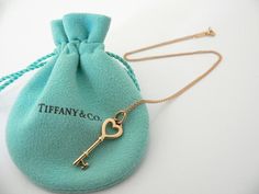 Overview:Time to show off your awesome Tiffany necklace! Offered for sale is a classic and very pretty Tiffany 
and Co. 18K Gold Heart Key Charm Necklace.   
Wonderful necklace that fits a lifestyle on the go -- the necklace can 
be worn to almost any occasion! Hanging from its beautiful Tiffany & Co. 18K Gold curb chain is a super pretty 18K Heart Key charm.  It is simple and yet looks extremely elegant.   Imagine the piece with your professional 
office attire ... Now imagine it with jeans Luxury Locket Necklace For Valentine's Day, Tiffany Key Necklace, Gold Key Necklace, Tiffany Key, Key Charm Necklace, Gold Curb Chain, Tiffany And Co Necklace, Tiffany Necklace, Professional Office