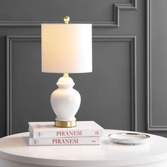 a white lamp sitting on top of two books