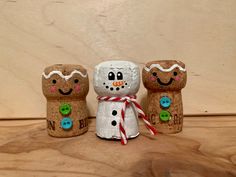 three wooden peg dolls made to look like snowmen